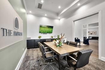 Conference room with a long table surrounded by chairs